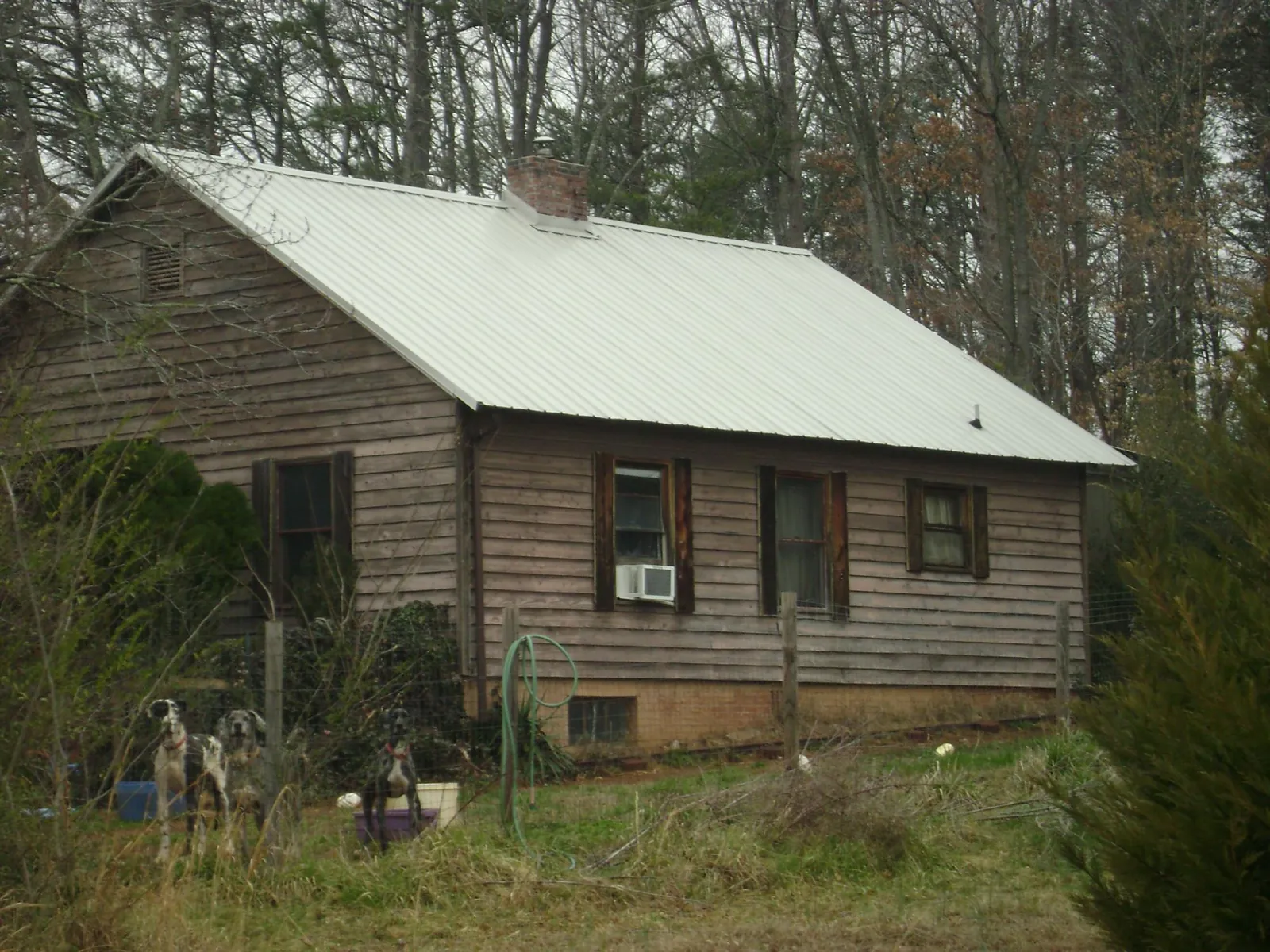 White metal roof on an old wood sided farmhouse, from a Metal Roof Installation job in Fort Loramie